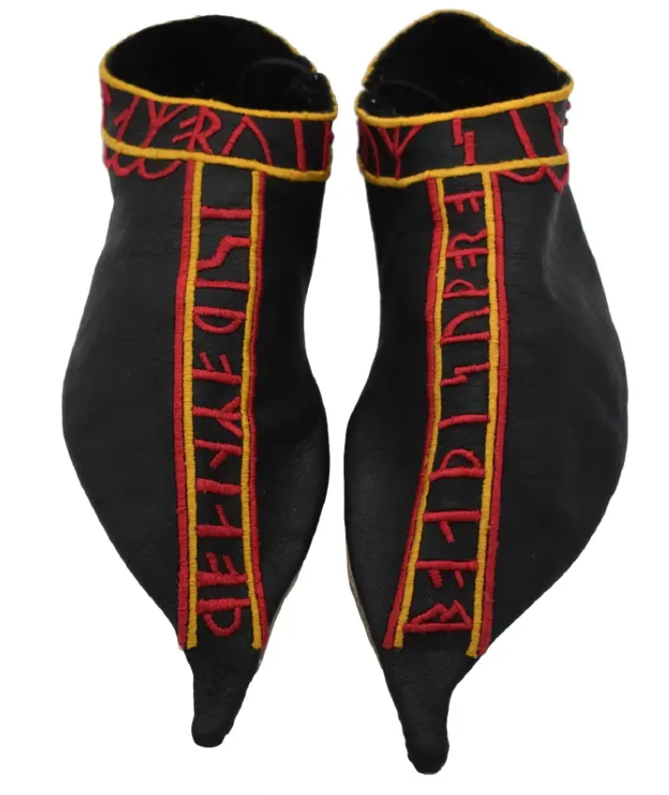 Pair of black leather shoes with red and yellow embroidered runes