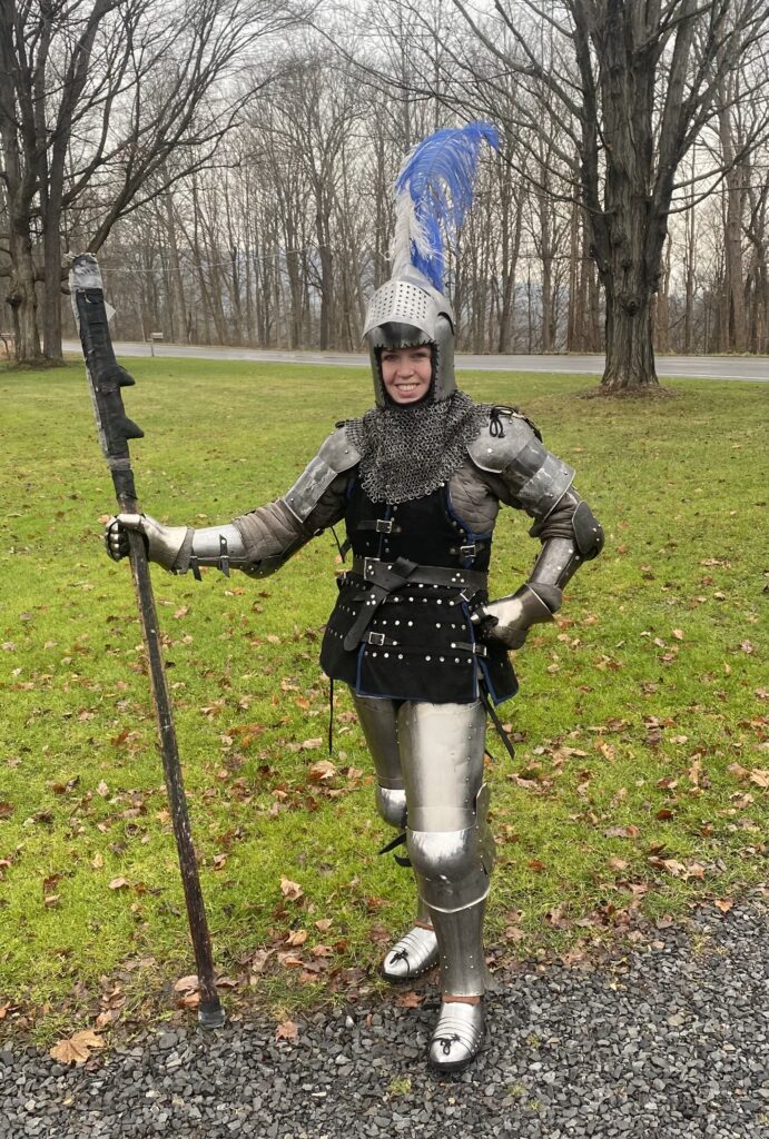 woman in full armor holding a pole-arm