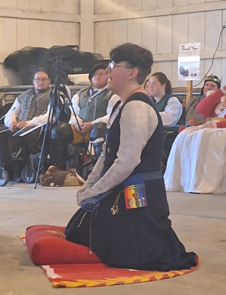 person kneeling before the kingdom royalty