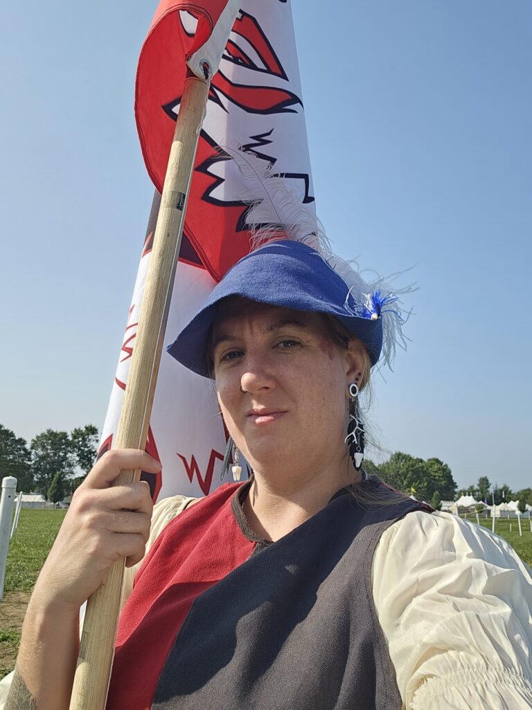woman holding a banner on a pole